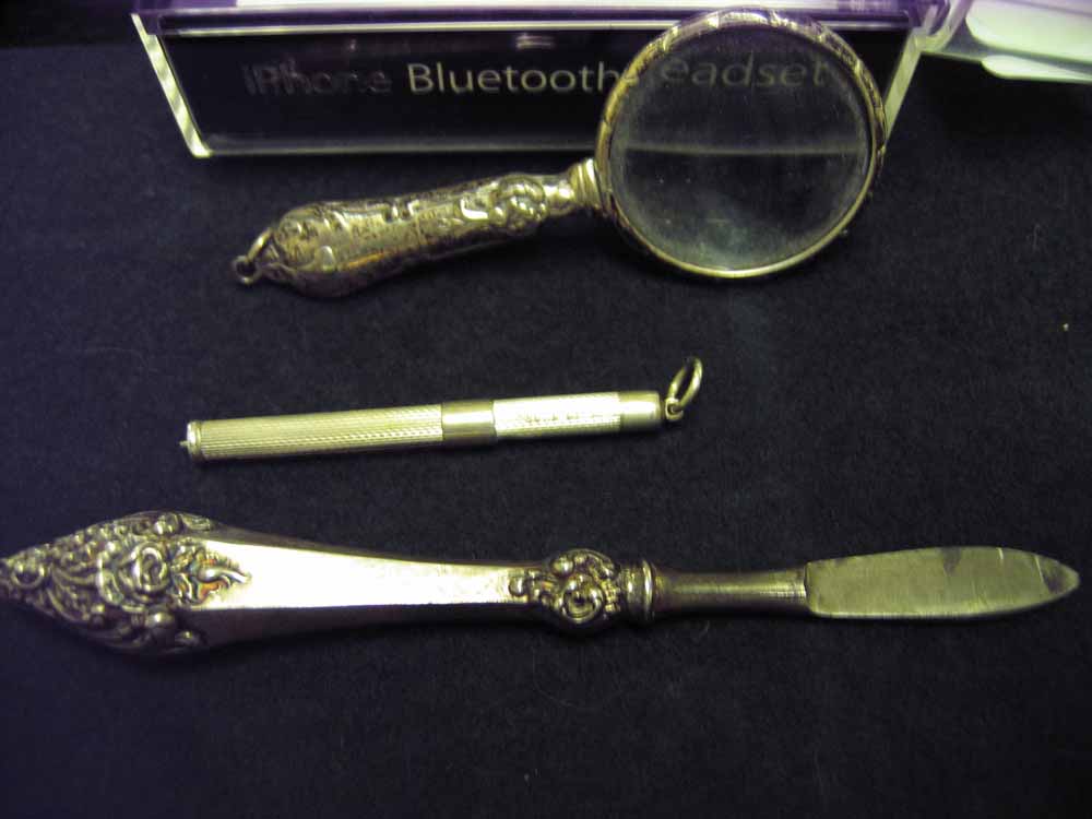 3 Hallmarked silver items to include a small magnifying glass.