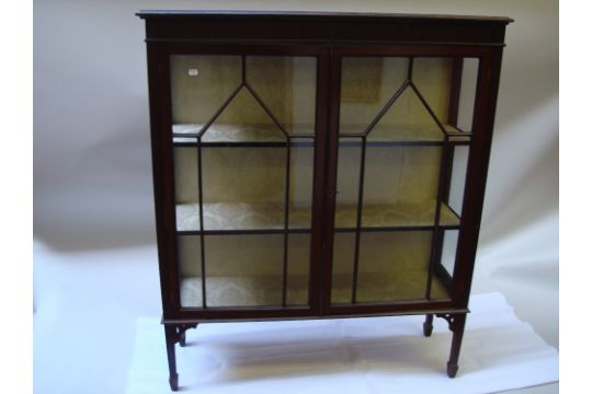 An Edwardian mahogany astragal glazed display cupboard