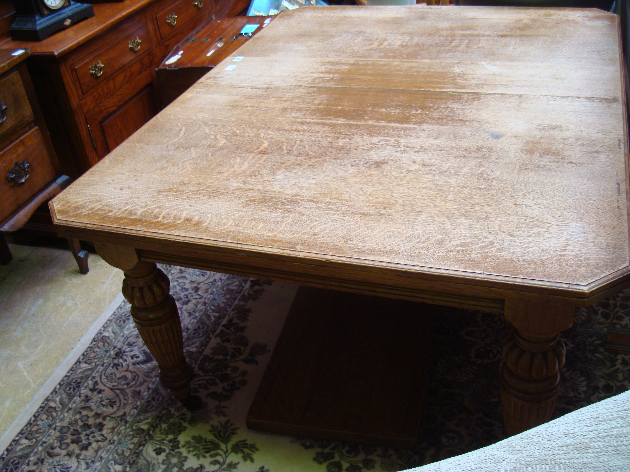 A late 19th century oak extending dining table with extra leaf