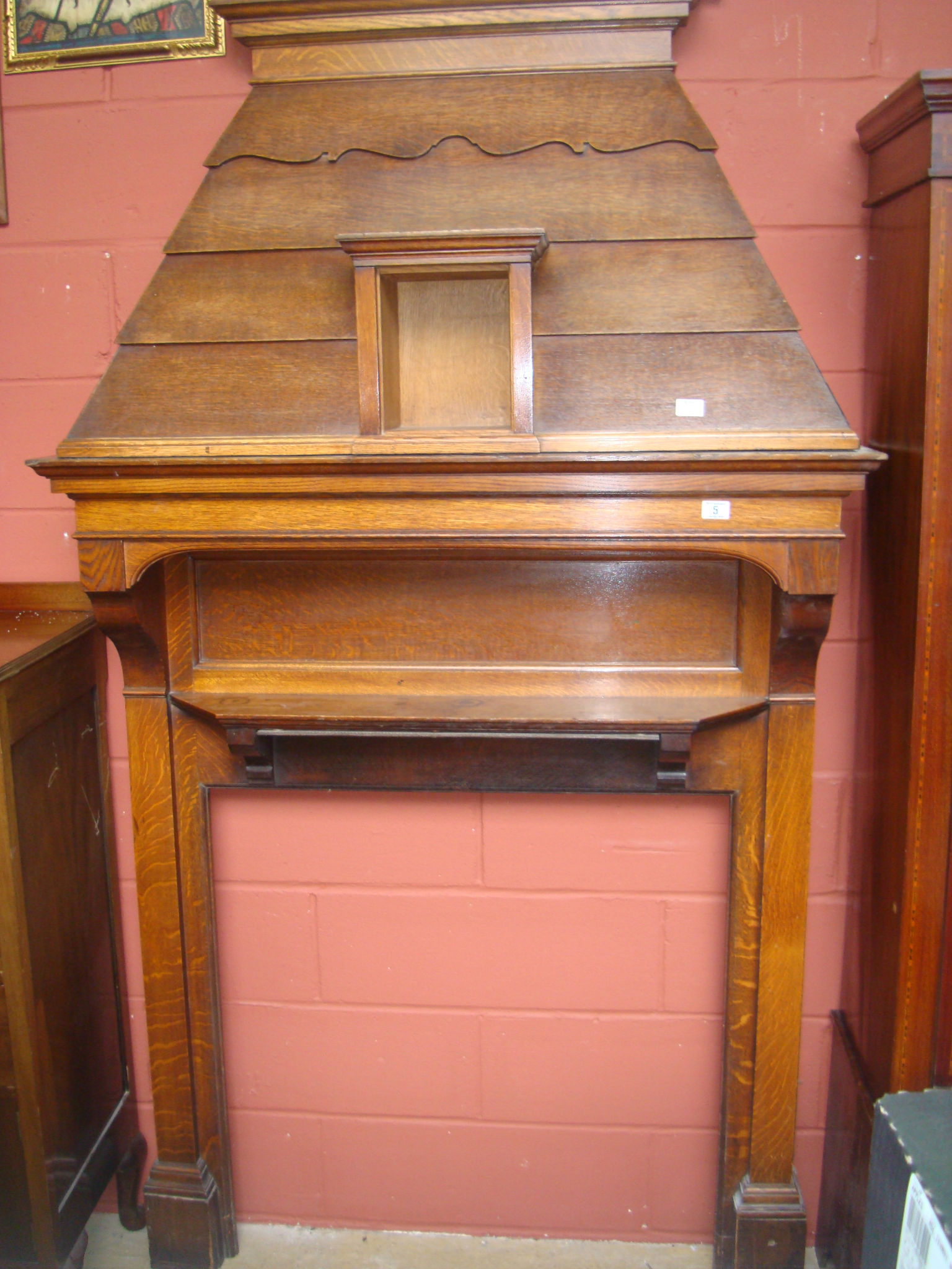 An early 20th century oak chimney piece