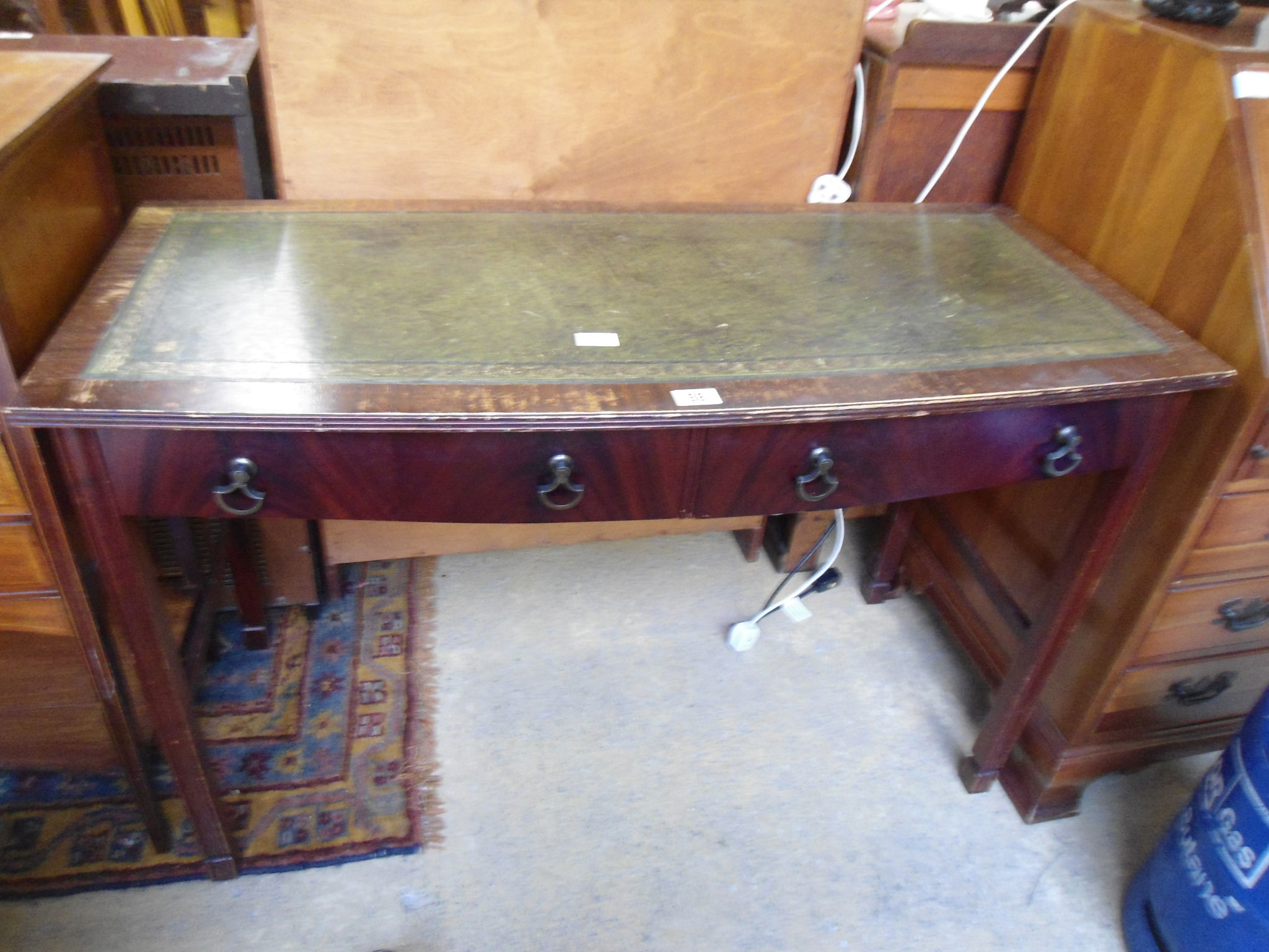 A reproduction bow front writing desk