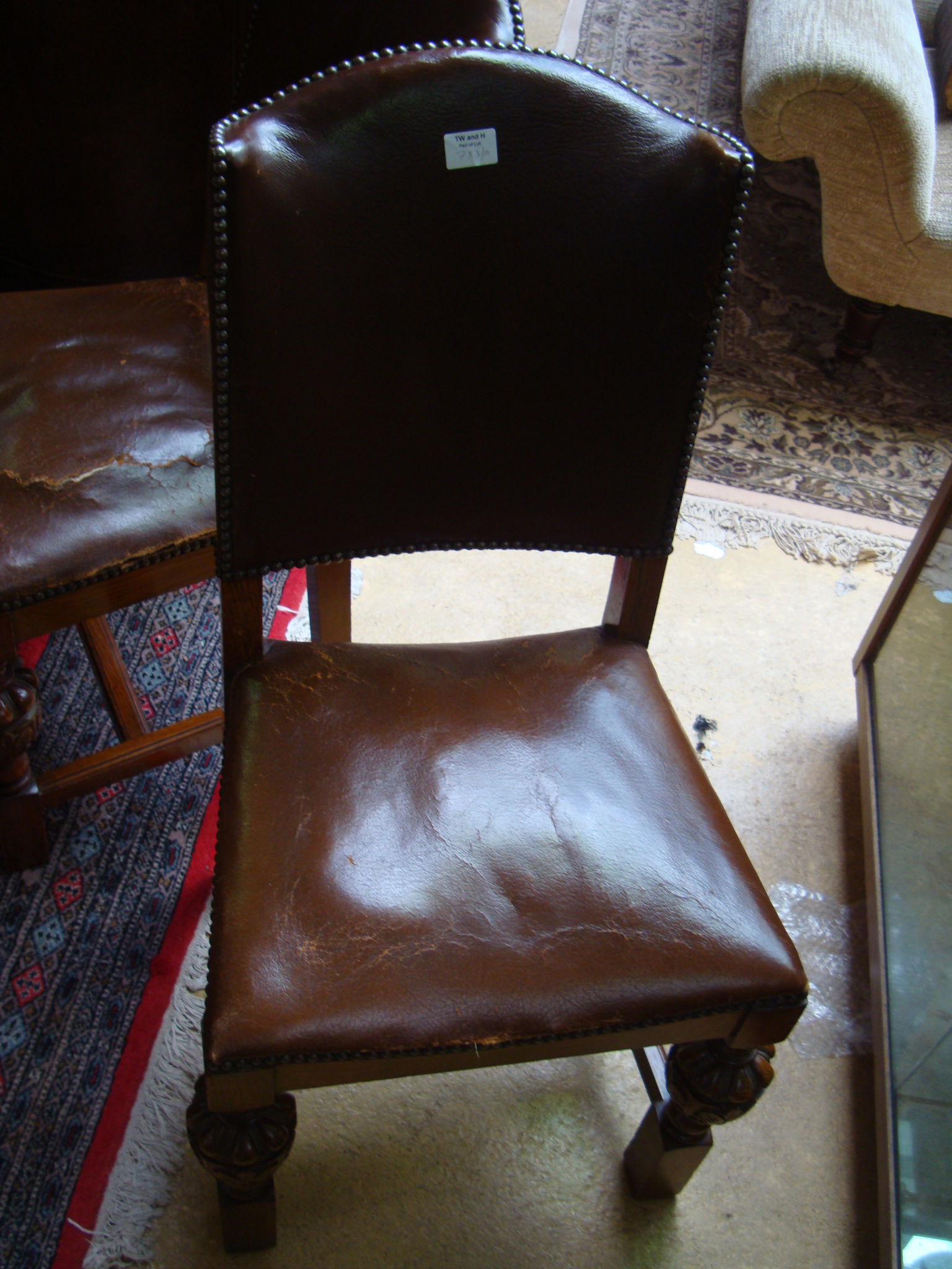 A set of four 1930s oak dining chairs upholstered in leather