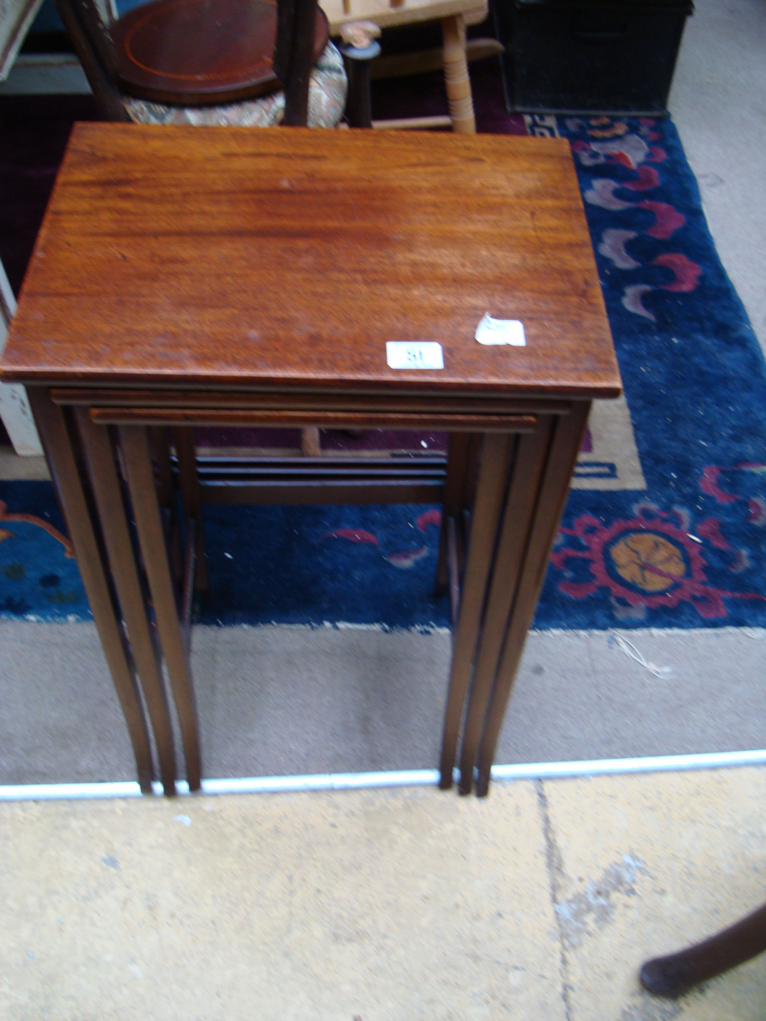 An early 20th century nest of three mahogany tables