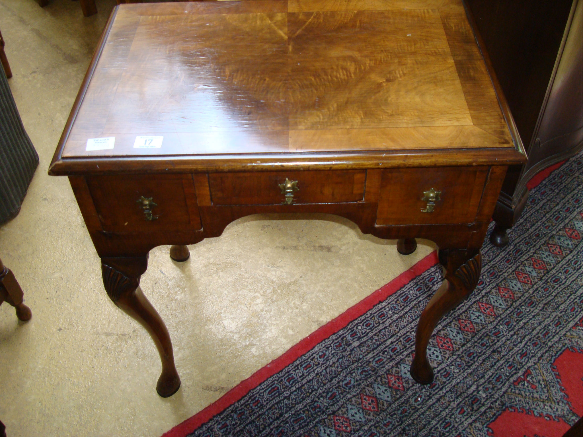 An early 20th century walnut Queen Anne style lowboy