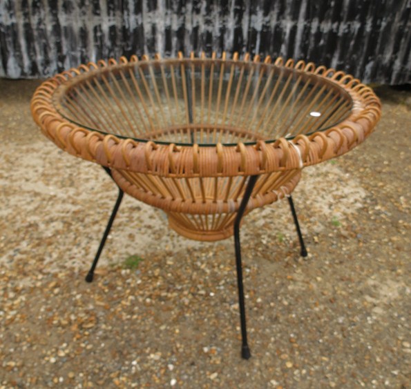 An Albini glass and cane circular coffee table on metal rod frame