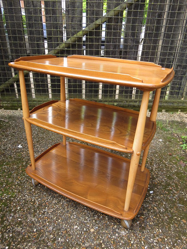 An Ercol light finish three tier tea trolley