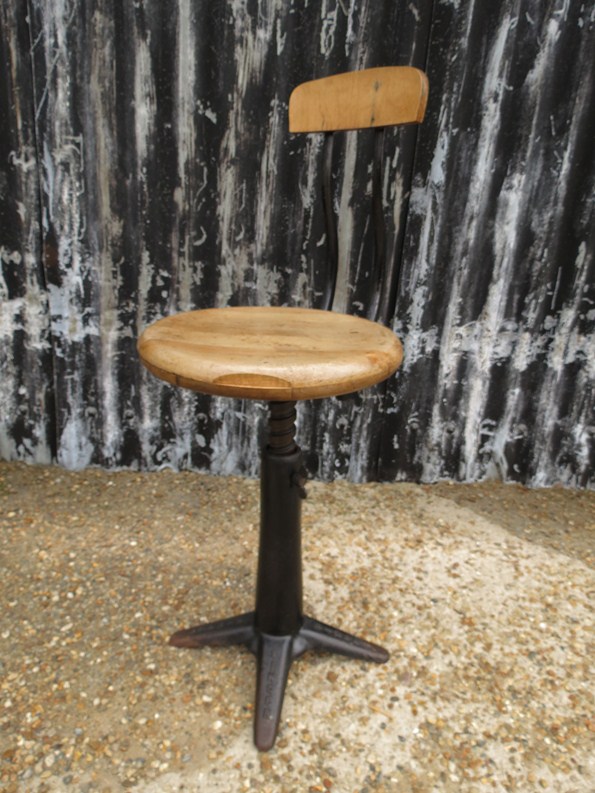 A Singer iron based stool with rise and fall wood seat, model 94500