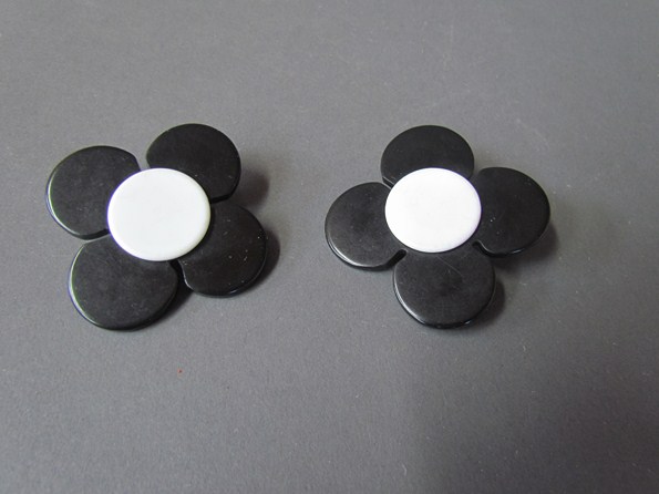 A pair of Mary Quant style black and white clip on earrings of flower form