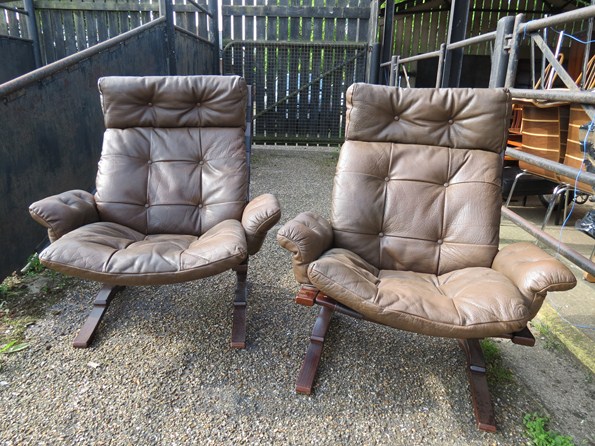 A pair of formed laminate and buffalo leather cantilever armchairs.