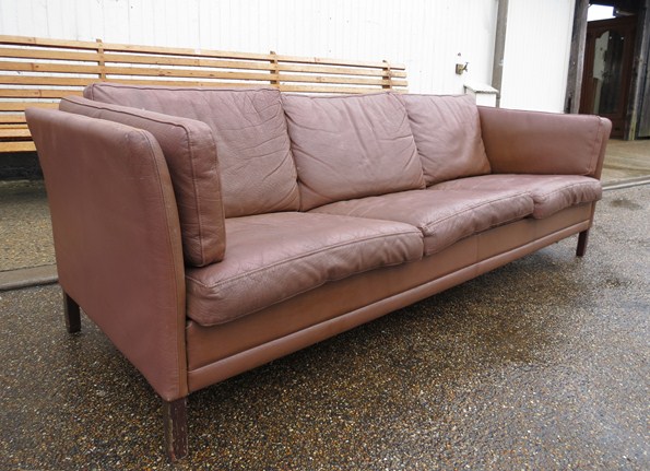 A coffee coloured leather three seater Danish sofa of London type.