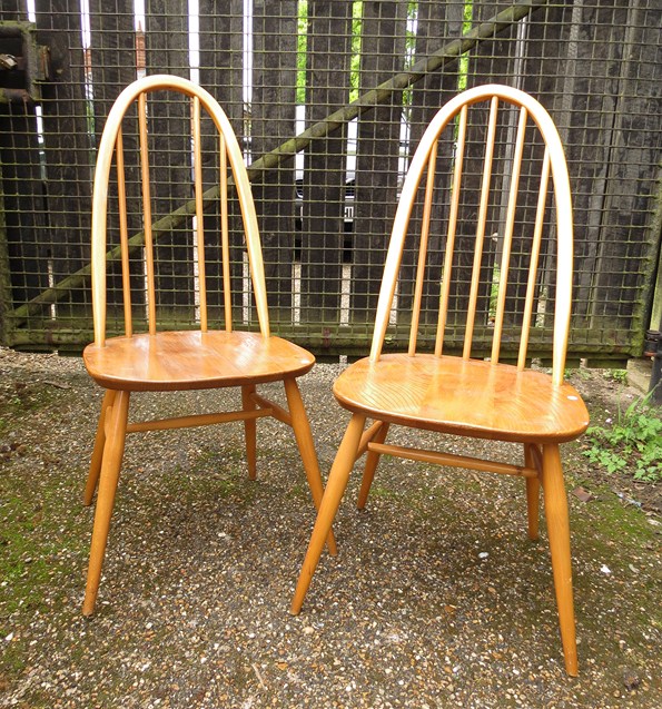 A pair of 1960s ercol light elm and beechwood hoopback, dining chairs (one spindle missing)