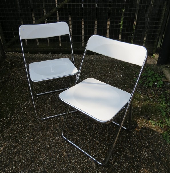 A pair of Castelli Plia chairs in white, labelled underside