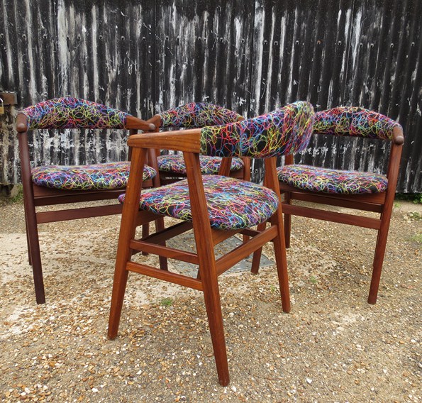 A set of four Danish style dining chairs in afromosla and teak with later upholstery