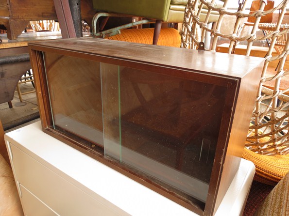 A Vanson wall mounting cabinet with twin sliding glass doors and shelved interior