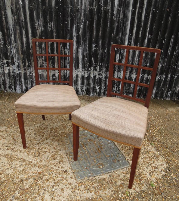 A pair of unmarked Betty Joel dining chairs in oak with lattice backs, upholstered seats.