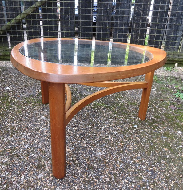 A teak coffee table with glass insert