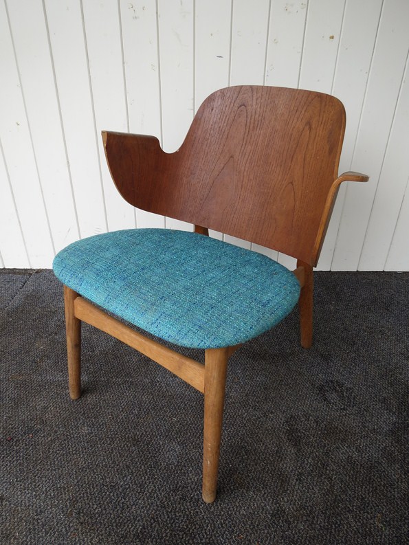 A Bramin formed laminate oak and beech framed lounge chair.