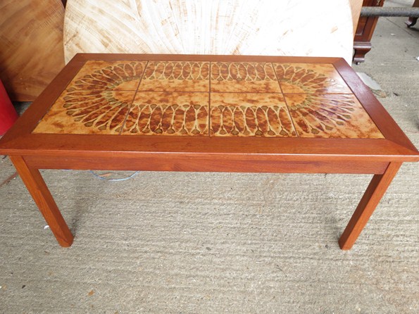 A teak framed tiled topped coffee table.