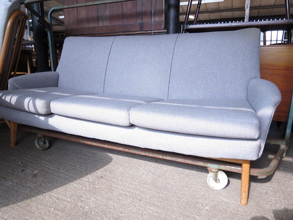 A 1960's Parker Knoll sofa on beech legs with grey wool upholstery