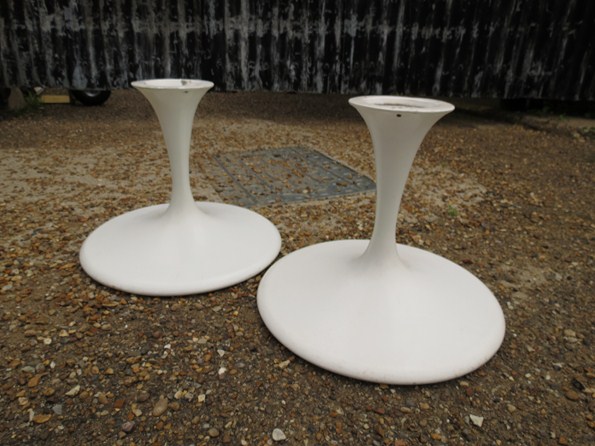 A pair of white tulip stool bases