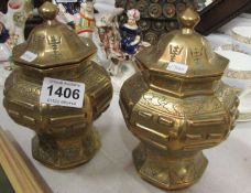 A pair of Oriental lidded brass jars