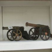 2 brass cannons on wooden carriages
