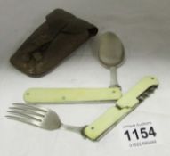 A folding spoon and fork in leather case