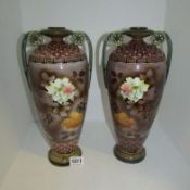 A pair of floral decorated vases, 37cm