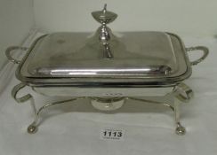 A silver plate breakfast tureen with stand and burner