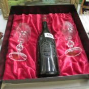 A bottle of commemorative wine and 2 glasses