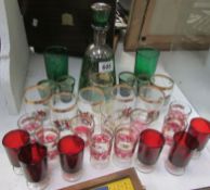 A green glass decanter and quantity of vintage glasses