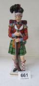 A Sitzendorf figure of a Scottish Highlander (a/f)