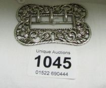 A silver buckle with Birmingham hallmark