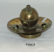An ornate brass inkwell with liner and set tiger's eye