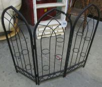 A wrought iron folding plant stand