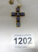 A 9ct gold cross set black opals on 9ct gold chain