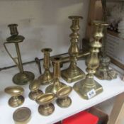 A mixed lot of brass candlesticks, doorstop etc