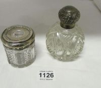 A silver topped perfume bottle and silver topped hair pot