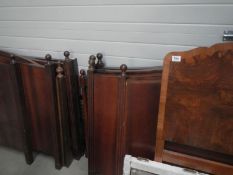 A quantity of mixed sizes dark wood headboards