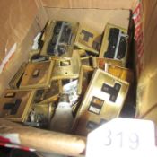 A box of brass coloured light switches