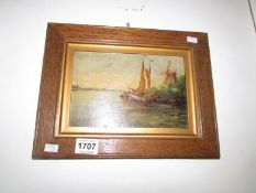 A Dutch oil on panel of canal barge with windmill, signed