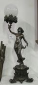 A spelter figure lamp with globe shade