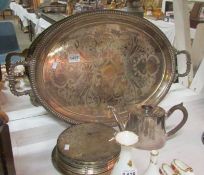 A large silver plated tray, place mats and teapot