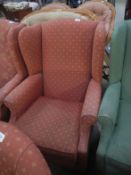 A pink wing armchair