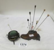 A bronze shoe hat pin cushion and an Irish bog oak Couldron pin cushion