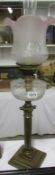 A brass Corinthian column oil lamp with glass font and shade