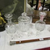 A cut glass biscuit barrel, 2 decanters and 4 glasses