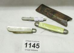A silver and mother of pearl penknife, one other and a leather cased penknife
