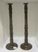 A pair of tall wooden candlesticks