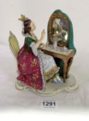 A Figurine of lady at dressing table marked Dresden, Made in Germany